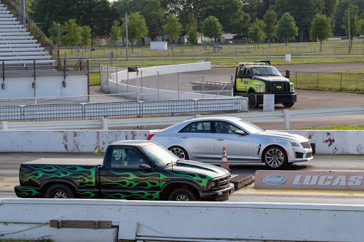 Unique matchup between Cadillac and pickup